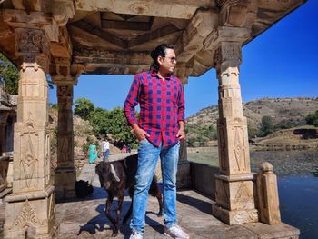 Full length of man standing against columns