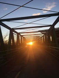 Railroad tracks against sky during sunset