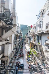 High angle view of people on street amidst buildings in city