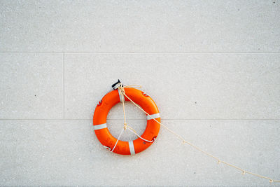 Red umbrella against orange wall