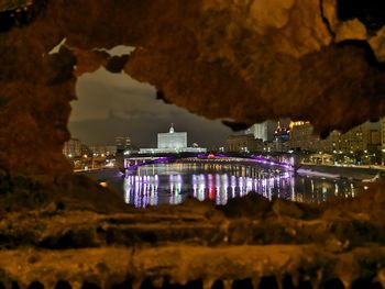 Illuminated city buildings at waterfront