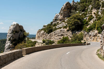 Road by mountain against clear sky