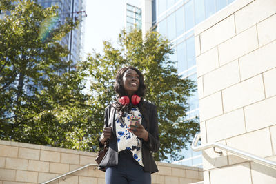 Low angle view of young woman looking at camera