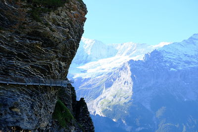 Scenic view of snowcapped mountains against blue sky