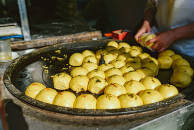 Midsection of man selling food at market stall