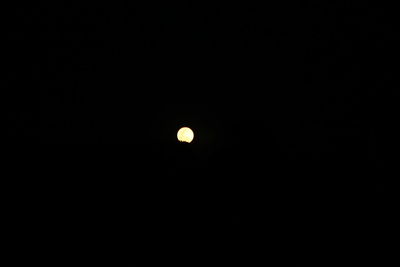 Low angle view of moon against clear sky at night