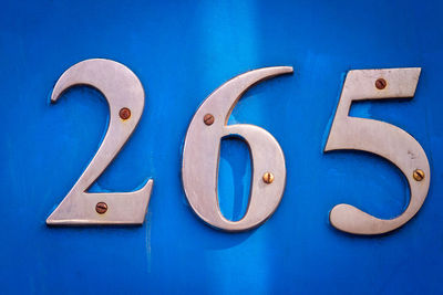 House number 265 on a blue wooden front door in london 