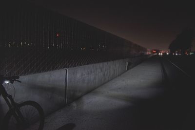 Cars on illuminated road against sky at night