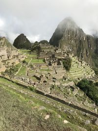 Scenic view of mountains against cloudy sky