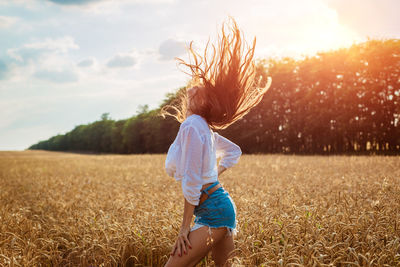 Beautiful young woman in wheat field. cute brunette girl
