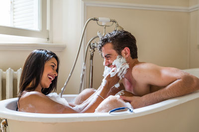 Couple kissing in bathroom at home