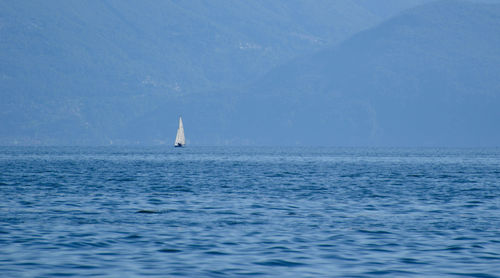 Sailboat in sea against sky