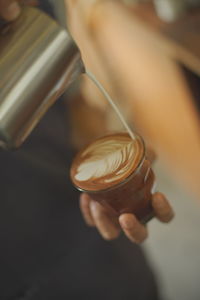 Close-up of hand holding coffee cup