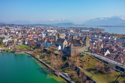 High angle view of townscape and mountains against sky