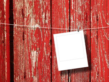 Close-up of paper hanging against wood