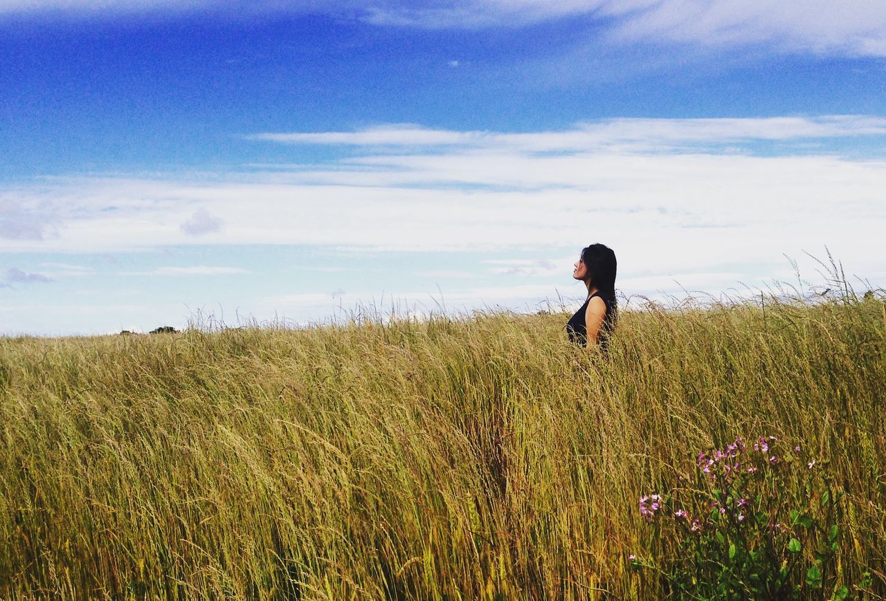 grass, field, sky, full length, leisure activity, lifestyles, landscape, tranquility, agriculture, tranquil scene, nature, growth, rear view, rural scene, grassy, beauty in nature, plant, casual clothing