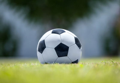 Close-up of soccer ball on grassy field