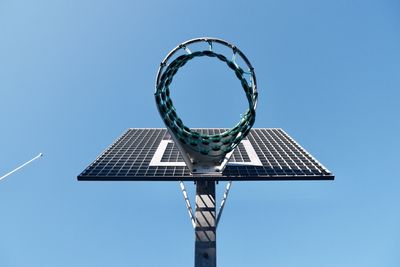 Low angle view of basketball hoop against blue sky