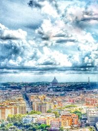 Aerial view of city against cloudy sky