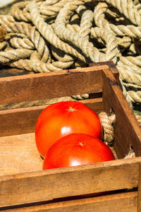 Close-up of red apple in crate