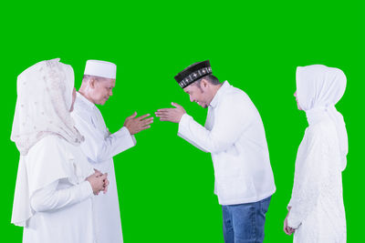 Panoramic shot of people standing against white background