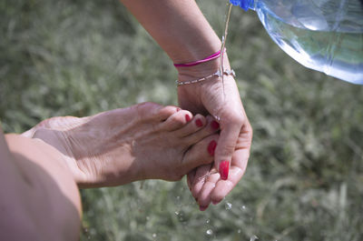 High angle view of woman washing leg