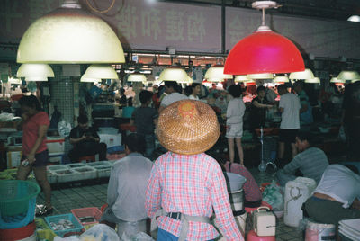 Rear view of people at market stall