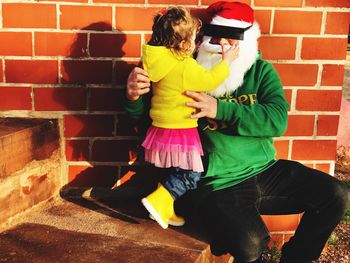 Girl sitting with father