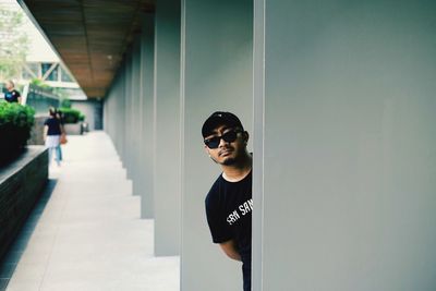 Portrait of young man wearing sunglasses standing outdoors