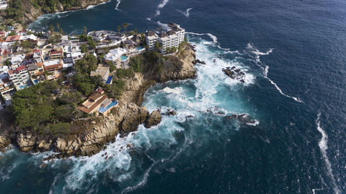 High angle view of buildings by sea