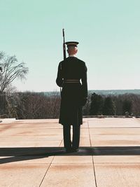 Rear view of man standing against sky