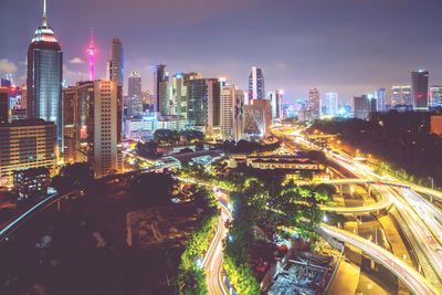 Aerial view of city lit up at night