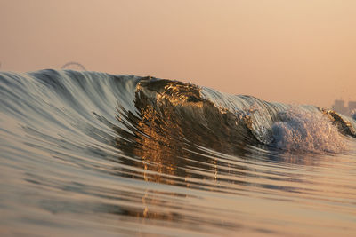 Wave at sea during sunrise
