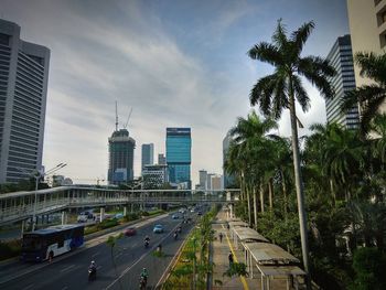 Cars on road in city against sky