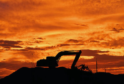 Backhoe silhouette at sunset