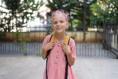 Portrait of smiling young woman standing outdoors