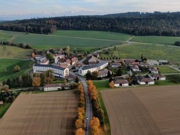 High angle view of houses on field against sky