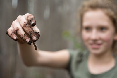 Close-up of girl with dirty hand