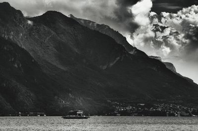 Scenic view of sea and mountains against sky