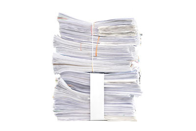 Close-up of paper stack against white background