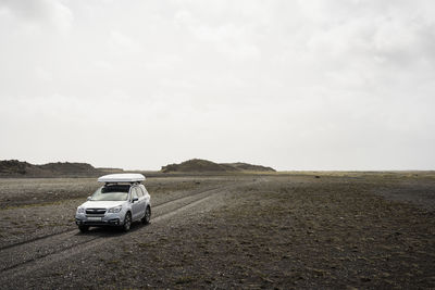 Car driving on gravel road in iceland