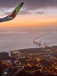 Aerial view of sea against sky during sunset