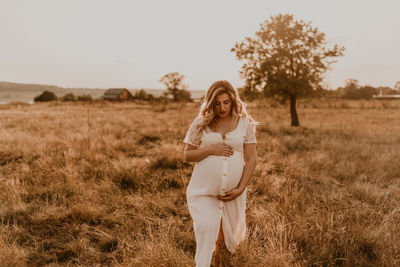 Side view of woman standing on field