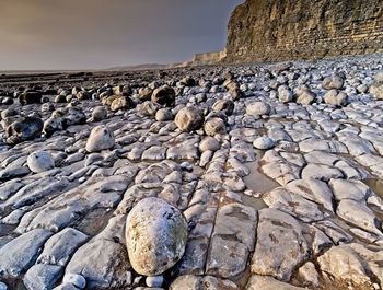 Rock formation on beach against sky jurassic coastline rock striated 