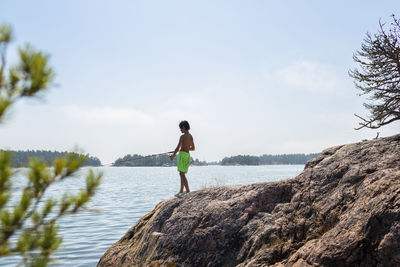 Boy fishing at lake