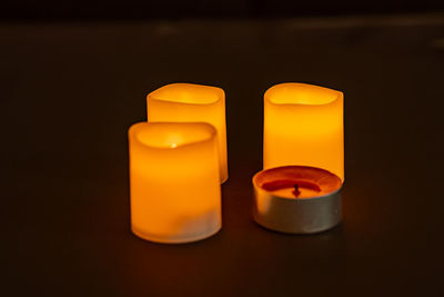 Close-up of lit candles on table