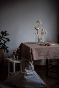 View of illuminated lamp on table against wall at home