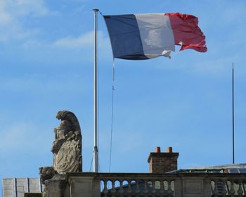 Low angle view of french flag against sky