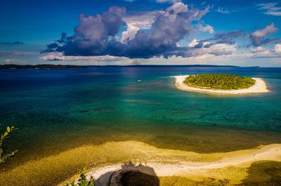 View of beach against cloudy sky