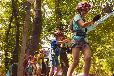 Rear view of people walking in forest